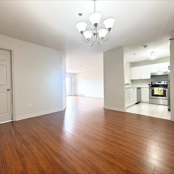 a kitchen with a stove top oven and a chandelier.