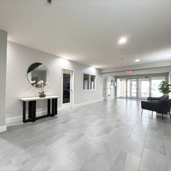 a spacious room with a bench and a mirror.