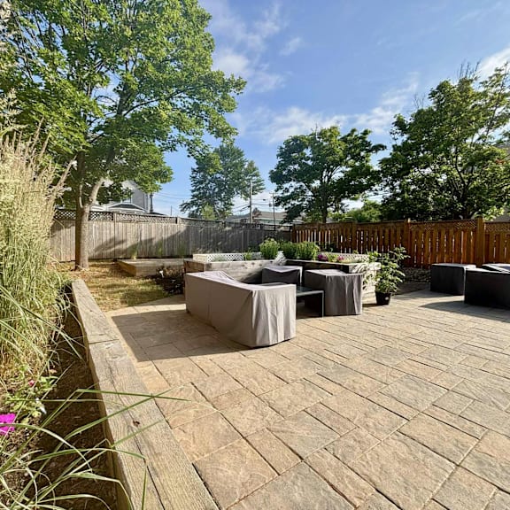 a backyard with a patio and a fence.