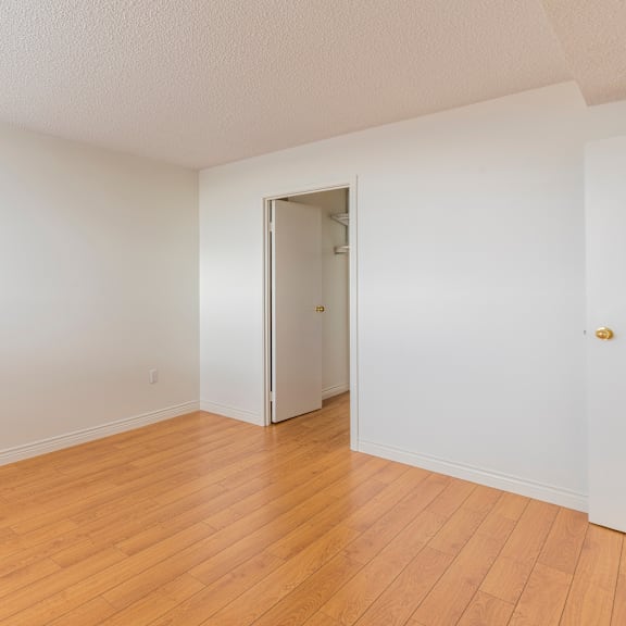 a room with wooden floors and a white door.