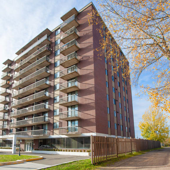a tall apartment building with balconies on each floor.