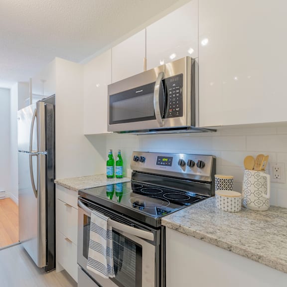 a modern kitchen with a stove, oven, and microwave.