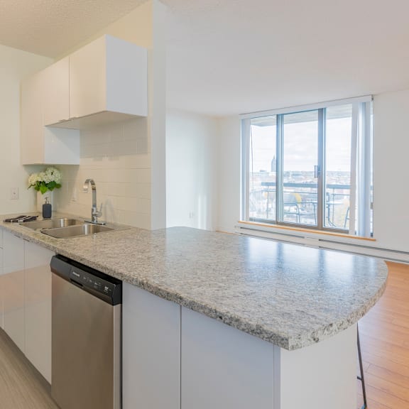 a kitchen with a granite countertop and stainless steel appliances.