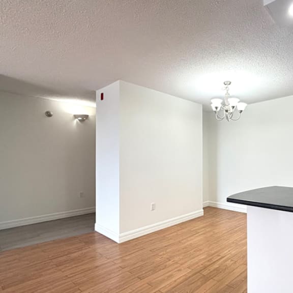 a room with a white wall and a black counter.