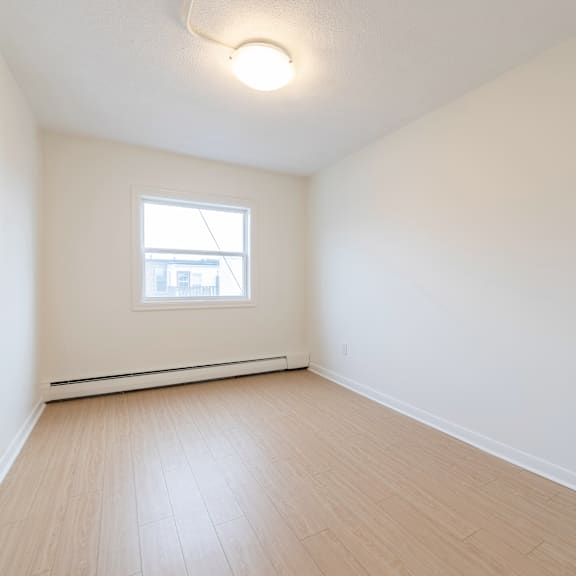a room with a window and a white ceiling.