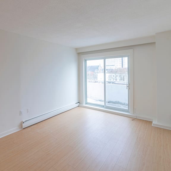 empty room with a sliding glass door leading to a balcony.