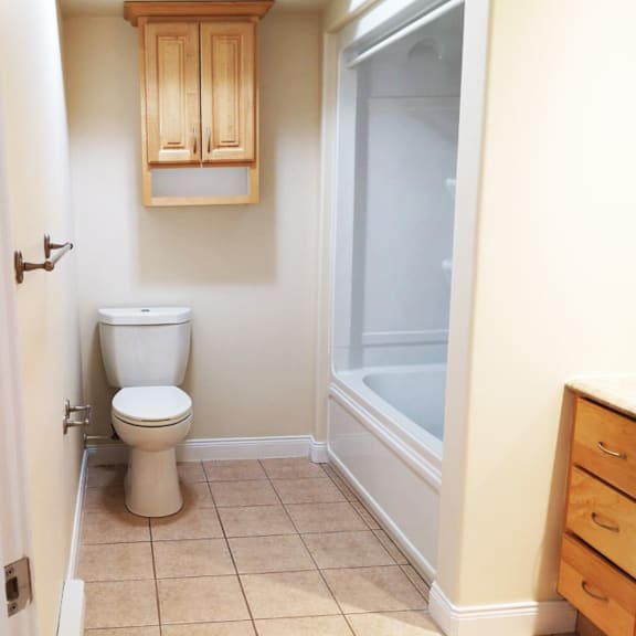 a white toilet sits in a bathroom next to a white door.