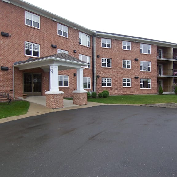 a large brick building with a covered walkway in front.