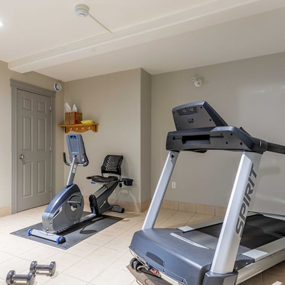 a spinning bike and a treadmill in a room.