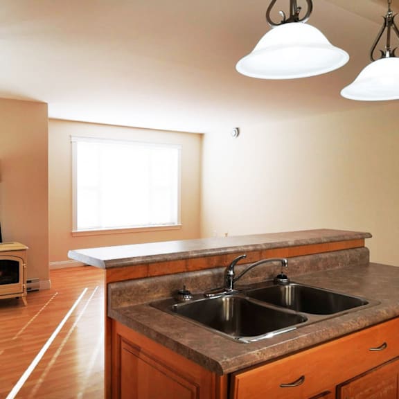 a kitchen with a wood stove and a sink.