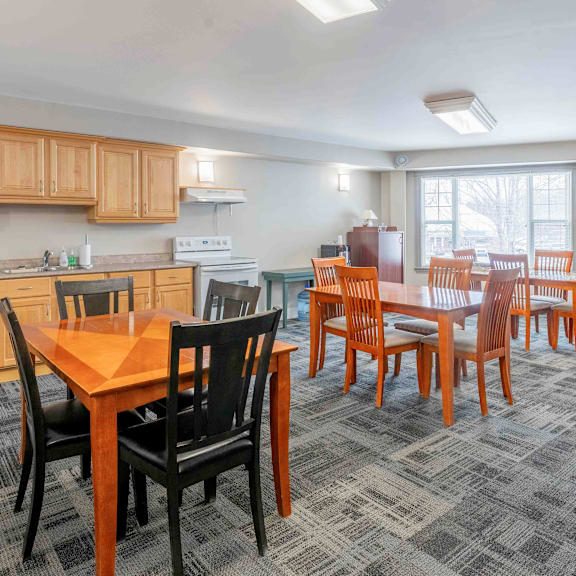 a kitchen with a dining table and chairs.
