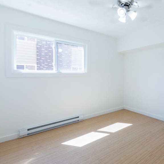 a room with a window and a radiator on the floor.