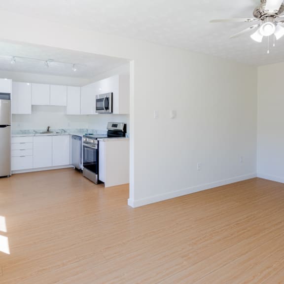 a kitchen with white cabinets and a stainless steel refrigerator.