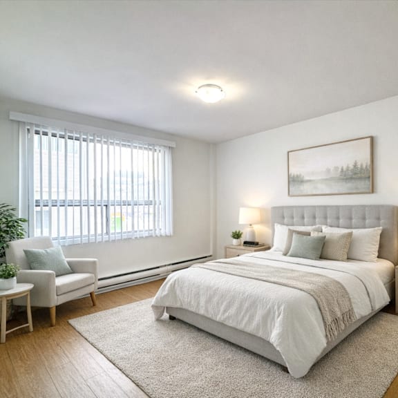 a bedroom with a large bed, a nightstand, a chair, and a painting on the wall.
