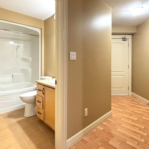 a bathroom with a toilet, sink, and bathtub.