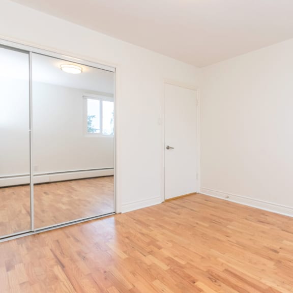a room with a white door and a sliding glass door.