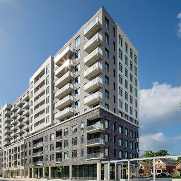 a modern multi-story building with balconies and large windows.