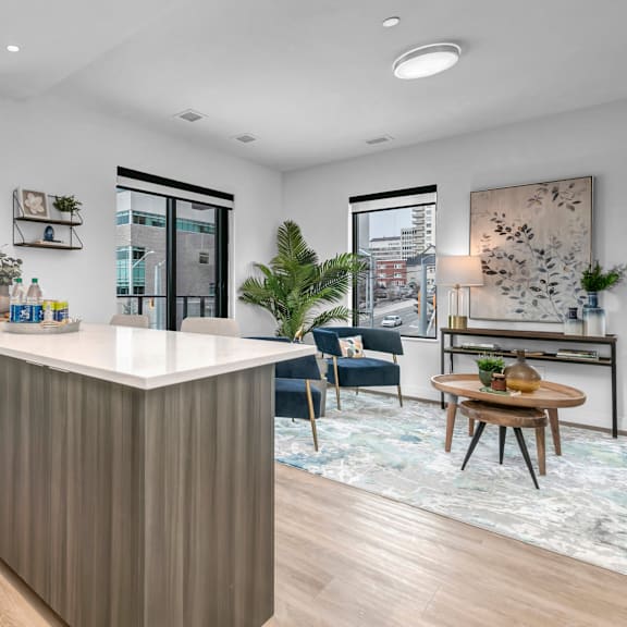 a modern kitchen with a white countertop and wooden cabinets.