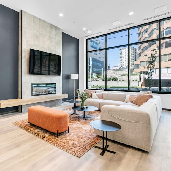 a modern living room with a fireplace and a large window.