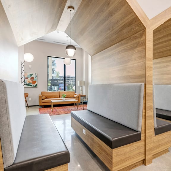 a room with a couch and two benches with a window in the background.