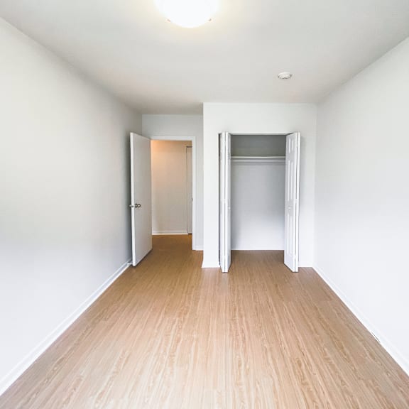 a room with a white wall and a wooden floor.