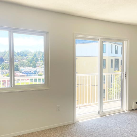 a room with a view of a residential area through the window.