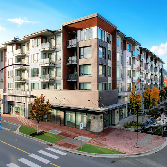 a modern apartment building with a street in front.