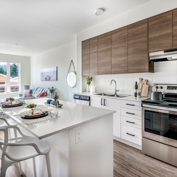 a modern kitchen with a dining table set for two.