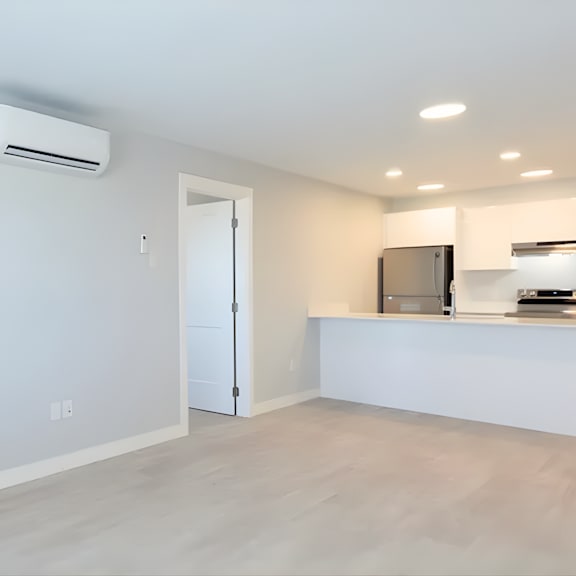 a modern kitchen with a white countertop and a stainless steel refrigerator.