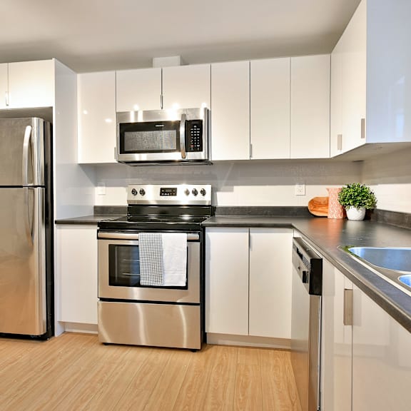 a modern kitchen with a stainless steel refrigerator and oven.