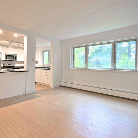 a kitchen with a refrigerator, microwave, and oven.