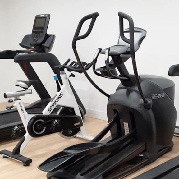 a spinning bike is on the left and a recumbent bike is on the right.