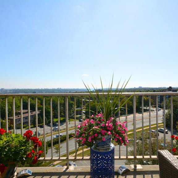 a balcony with a view of the street and buildings.