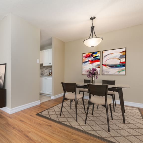 a dining room with a table set for four.