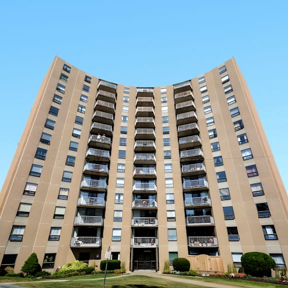 a tall, curved building with balconies on each floor.