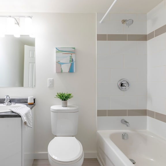 a white toilet sits next to a white sink in a bathroom.