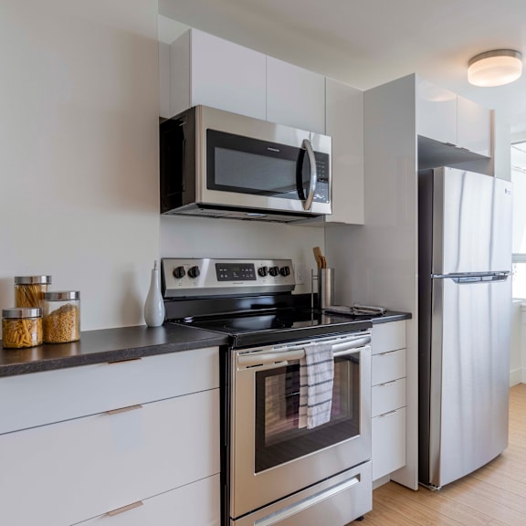 a modern kitchen with a stove, oven, and refrigerator.