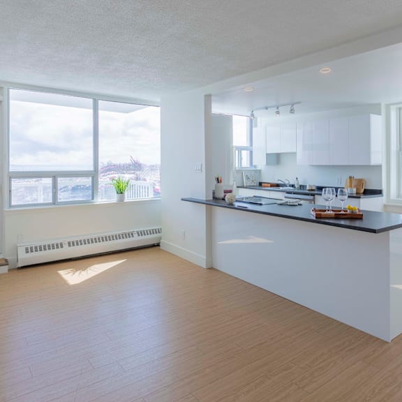 a spacious kitchen with a large island and wooden flooring.