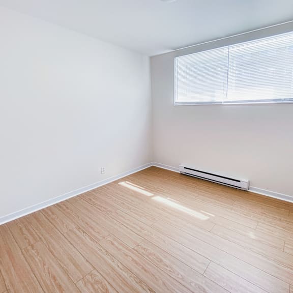 a room with a window and a radiator on the floor.