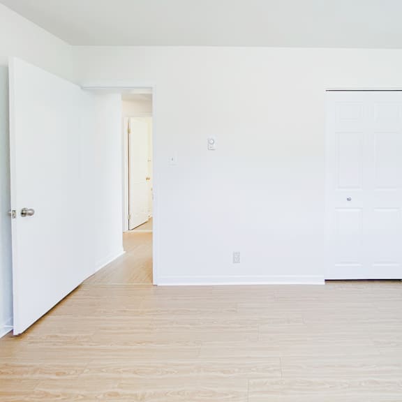 a room with a white door and a white wall.