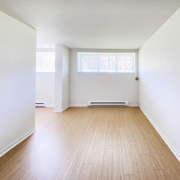 a room with wooden flooring and a window.