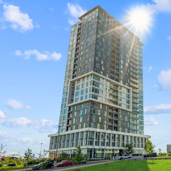 a tall building with many windows is basking in the sunlight.