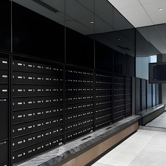 a long hallway with a row of mailboxes on the wall.