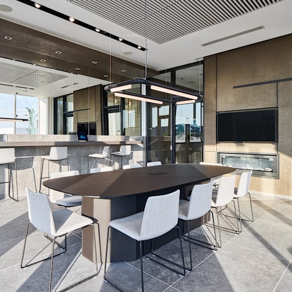 a modern dining room with a large table and chairs.
