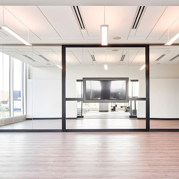 a modern office space with a large screen in the center.