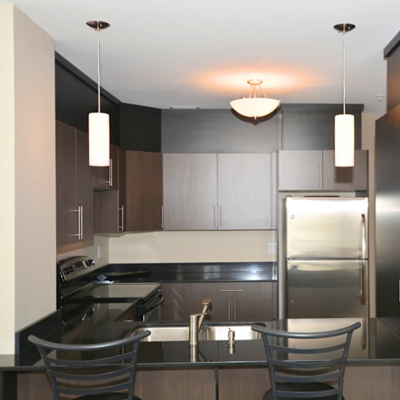 a modern kitchen with a stainless steel refrigerator and a sink.
