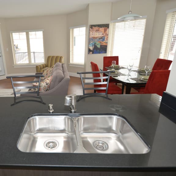 a kitchen with a sink and a dining table.