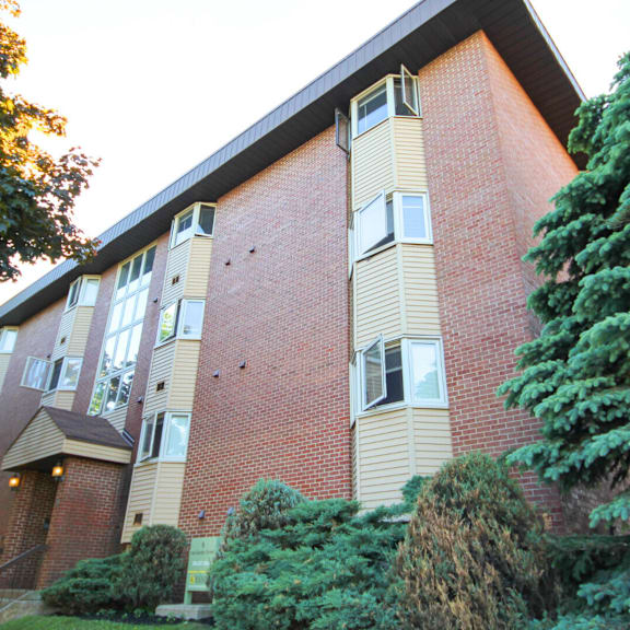 a red brick building with a balcony on the second floor.