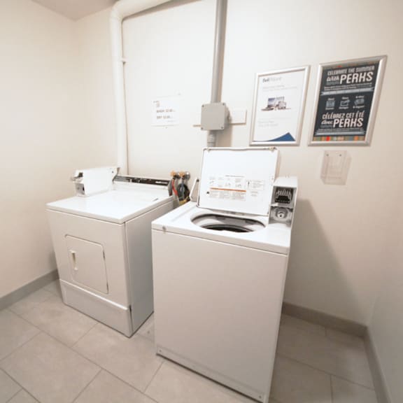a washing machine and dryer in a small room.