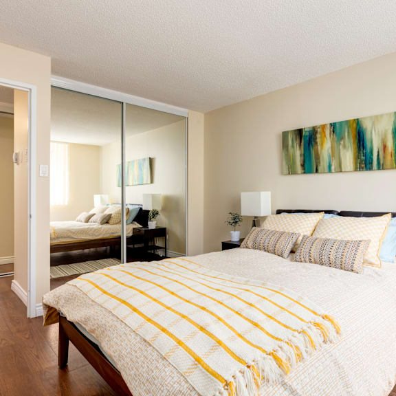 a bedroom with a large bed and a painting on the wall.